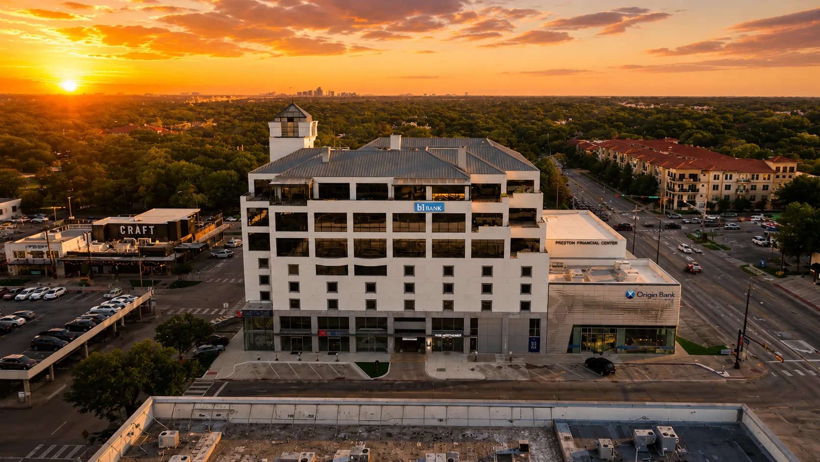 Front elevation with Preston Financial Center signage at sunset